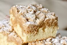 several pieces of cake sitting on top of a white plate with powdered sugar toppings