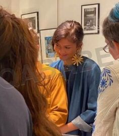 three women are talking to each other in an office