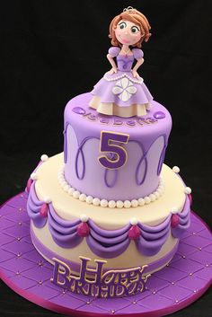 a purple and white birthday cake with a princess on top