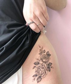 a woman's stomach with a rose tattoo on the side and her right arm