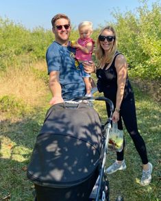 a man and woman with a baby in a stroller