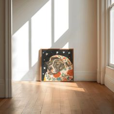 a dog is sitting on the floor in front of a painting