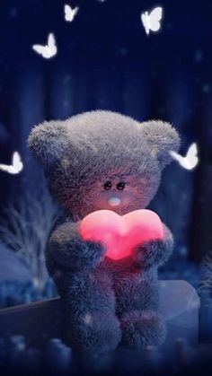 a teddy bear holding a heart in its paws