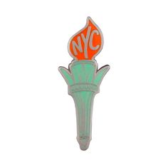 an orange and green pin with the word nyc on it