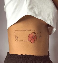 a woman's stomach with a flower tattoo on her lower side ribcage