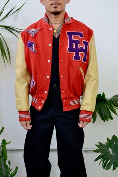 "Seventies \"DeLong Sportswear\" Red And Beige Letterman Jacket. Snaps Closure Up Front. Two Pockets. \"David Johnson\" Name Patch On Back. Sheep Face, Winged Shoe, \"EH\" And \"79\" Patches On Front. Small Shawl Collar. Ribbed Cuffs, Collar And Waist. Quilted Lining. Shell 80% Reprocessed Wool 15% Unknown Reprocessed Fibers 5% Other Fibers, Lining 100% Rayon, Interlining 50% Acrylic 50% Other Fibers Great/Good Vintage Condition - Pilling. Loose Threads. Marks On Sleeves. General Discolouration