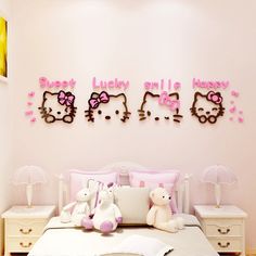 there are hello kitty wall decals on the wall above the bed in this bedroom