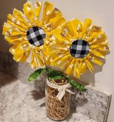 two yellow sunflowers in a mason jar