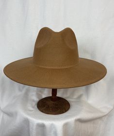 This Camel 100% wool-felt 4-inch Stiff Brim has a pinched fedora crown. The inside brim has a sizing cord and will fit up to 22 7/8 inch head size.  NOTE: Please check the head size before purchase, I am happy to answer any questions you may have. The budget hat collection is not eligible for return. Beige Felt Hat With Flat Brim For Fall, Wide Brim Beige Felt Hat For Winter, Beige Wool Felt Hat For Fall, Beige Flat Brim Felt Hat For Winter, Beige Wide Brim Felt Hat For Winter, Beige Curved Brim Felt Hat For Fall, Fall Wool Beige Fedora, Fall Beige Felt Hat With Curved Brim, Fall Beige Wool Fedora