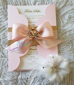 a pink and gold wedding card with a large bow