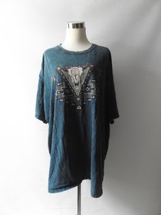 vintage 90s skull southwest print t-shirt.  blue green stone wash like pattern throughout.  front buffalo skull print with western inspired pattern.  size 3xl on tags, see measurements for fit.  LABEL -- gildan t-shirt MATERIAL -- 100 cotton  CONDITION -- great worn in vintage -- small holes front and back, see pictures Measurement in inches size -- 3XL on tags length -- 31.5 sleeve length -- 8.5 armpit to armpit resting/doubled -- 56 across upper back -- 26 Southwest Print, Skull Print, Baggy Fits, Print T Shirt, Sleeve Length, Tops & Tees, Adult Outfits, T-shirt, Top Outfits