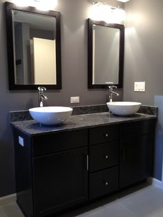 two sinks in a bathroom with mirrors above them