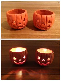 two pumpkin shaped candles sitting on top of a table