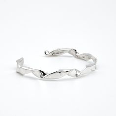 Our twisted silver cuff is true artistry and simplicity! A single strand of sterling silver is flattened, then hand twisted. A sleek, high shine is the finishing touch to this contemporary bracelet that is perfect for men and women. Expect your twisted sterling silver cuff to arrive in a velvet pouch, along with a polishing cloth. All our jewelry is artisan-crafted to last a lifetime, and ships worldwide, free of charge. Modern Twist Silver Bracelets, Modern Twist Sterling Silver Bracelets, Elegant Hand-wrapped Silver Cuff Bracelet, Modern Twist Polished Bangle Cuff Bracelet, Sterling Silver Twisted Cuff Bangle, Contemporary Bracelets, Sleeping Beauty Turquoise, Velvet Pouch, Pendant Rings