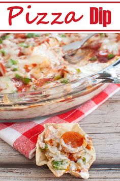 a close up of a pizza dip in a glass dish on a red and white checkered napkin