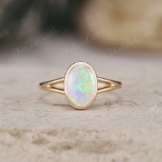 Unique Opal Engagement Ring Solid Gold Rings Art Deco Bezel Set Ring Vintage Oval cut Rainbow Opal Ring Minimalist Wedding Rings For Women ITEM DETAILS ●Available in yellow, white or rose solid 10k, 14k or 18k gold. This ring can be made in Platinum. ❀❀Center Stone: Natural Opal Shape: Oval shape Size: 6x9mm Band width around 1.5mm Visit my shop for more jewelry: https://www.etsy.com/shop/TheRoseCastle if you would like to customize your unique ring, you may contact us about your ideas and pictures. Hope I could get the chance to create fabulous rings for you! ❀Production ---- This ring is handmade and very good quality! Please allow 2-4 weeks for production. It can be made to any ring size.  ❀Engraving service We accept the engraving order, leave a note when placing an order or contact us Opal Ring Bezel Set, Bezel Opal Ring, Opal Gold Necklace, Minimalist Oval Cabochon Wedding Jewelry, Oval Opal Ring For Anniversary, Gold Opal Stackable Ring With Oval Shape, Oval Opal Promise Ring, Modern Gold Oval Opal Ring, Minimalist Oval Cabochon Opal Ring For Anniversary