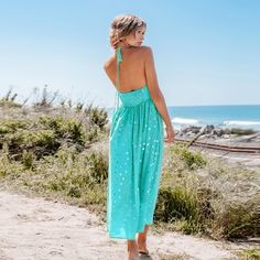 Add a touch of whimsy to your everyday wardrobe with our Mint Polka Dot Halterneck Midi Dress. Versatile and stylish, its comfortable fit and playful polka dot print make it perfect for any outdoor parties or brunch dates. Whether you're attending a garden party or enjoying a beachside dinner, this versatile dress is your go-to choice for any warm-weather occasion. Product code: CAA05A4D125PG Polka Dot Summer Sundress For Beach, Polka Dot Beach Dress For Spring, Spring Polka Dot Beach Dress, Polka Dot Dress For Spring Beach Occasion, Polka Dot Sundress For Spring Vacation, Spring Polka Dot Sundress For Vacation, Casual Polka Dot Maxi Dress For Beach, Casual Polka Dot Maxi Dress For Vacation, Polka Dot Summer Beach Dress