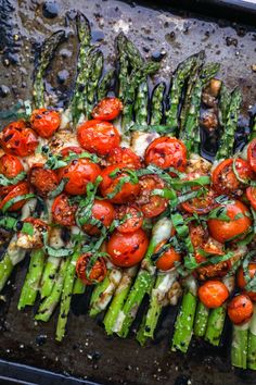 asparagus, tomatoes and other vegetables on a grill