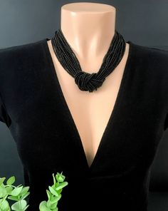 This stunning choker can be as short or as long as you wish. The black bead is a little sparkly and very high quality. Available with silver or gold clasp. It looks very elegant and the color is very classic It has 20 strands. The size shown in the picture is 18" . Please read specifications on SIZES below: ❤ SIZES This item comes in several sizes. Kindly choose at checkout. You can use the diagram on the pictures as a reference, but keep in mind that we all have different neck and body sizes so Elegant Black Beaded Necklace With Tiny Beads, Black Tiny Beads Necklace For Party, Black Necklace With Tiny Beads For Party, Black Bohemian Beaded Necklaces For Weddings, Elegant Black Tiny Beads, Adjustable Black Beaded Necklace For Wedding, Adjustable Beaded Choker Necklace For Evening, Elegant Tiny Beads Choker, Bohemian Black Choker For Wedding