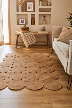 a living room filled with lots of furniture and rugs on top of hard wood flooring