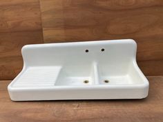 a white sink sitting on top of a wooden counter