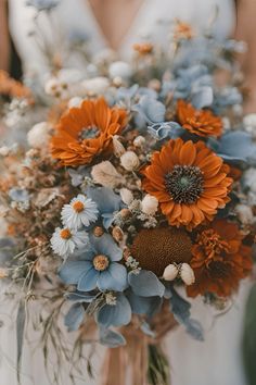 Dusty blue and burnt orange wedding bouquet    Dusty blue burnt orange wedding | dusty blue wedding | burnt orange wedding | rust orange wedding | dusty blue burnt orange wedding theme | dusty blue burnt orange wedding flowers | dusty blue burnt orange wedding ideas | wedding bouquet | fall wedding bouquet | fall wedding bouquet ideas Dusty Blue And Copper Wedding Theme, Powder Blue And Orange Wedding, Steel Blue Fall Wedding, Burnt Orange Navy Blue Color Palette, Rust Orange And Dusty Blue Wedding, Dark Teal And Burnt Orange Wedding Flowers, Teal And Orange Flowers, Burnt Orange Light Blue Wedding, Teal Wedding Aesthetic