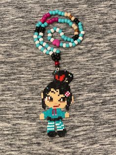 Mini Perler Necklace of Vanellope VonSweetz from Wreck it Ralph with matching strand! Handmade Themed Multicolor Jewelry, Handmade Multicolor Themed Jewelry, Handmade Adjustable Themed Necklace, Fun Handmade Necklaces For Festivals, Fun Handmade Necklace For Festivals, Fun Handmade Necklaces For Festival, Multicolor Beaded Themed Jewelry, Themed Multicolor Necklace For Gift, Themed Beaded Multicolor Jewelry