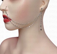 an image of a woman with piercings on her ear and nose chain attached to the side of her face