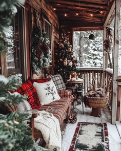 the porch is decorated for christmas with plaid furniture