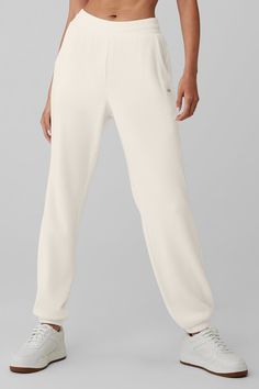 You'll chill in them, take walks around the block in them, tackle long-haul flights in them—these lounge pants are that good. They're made from a soft, warm waffle knit with a stretchy high-rise waistband, a laid-back (but not loose) fit and cozy ankle cuffs. Side pockets and a tonal Alo patch round it all out. And for cutest results, pair them with the matching bra and mock neck shirt. White Full Length Comfortable Sweatpants, Alo Yoga Sporty Loungewear Bottoms, White Full Length Sweatpants For Loungewear, Sporty Beige Sweatpants For Loungewear, White Casual Activewear By Alo Yoga, White Sweatpants With Elastic Waistband For Relaxation, White Casual Sweatpants For Relaxation, Beige Athleisure Bottoms For Loungewear, Casual White Sweatpants For Relaxation