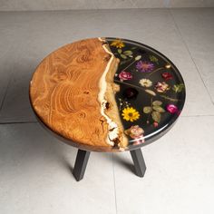 a wooden table with flowers on it and a piece of cake in the middle that has been cut out