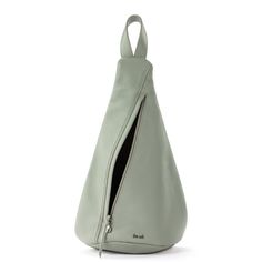 a light green leather bag with zippers on the front and side, open to reveal an inner compartment