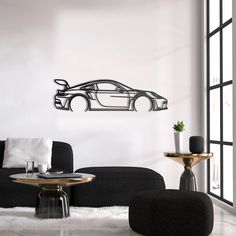 a living room filled with black furniture and white walls