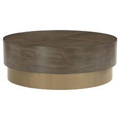 a round wooden table with metal trim around the top and bottom, on an isolated white background