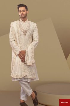 Make a Grand Statement on Your Special Day This Sherwani Design is available in two colours: Off White (1st Pic) & Cream/Beige. Choose as per your liking. Step into luxury with a Handmade Sherwani / Achkan crafted from premium soft blended silk, velvet and cotton blends in a stunning Cream / Gold colour, offering both comfort and sophistication. Our diverse collection features designs to suit every taste: Classic Elegance: Choose a timeless Sherwani with intricate embroidery on the collar or cuf Gold Bandhgala With Bollywood Style Chikankari Embroidery, Cream Churidar For Reception In Transitional Season, Cream Churidar For Reception, Transitional Cream Churidar For Reception, Cream Churidar For Reception With Traditional Drape, Semi-stitched Sherwani With Zari Work For Wedding, Traditional Gold Bandhgala With Chikankari Embroidery, Gold Bandhgala With Chikankari Embroidery, Beige Sherwani With Chikankari Embroidery For Reception