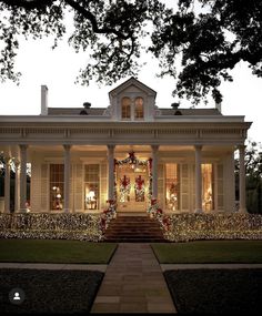 a large white house with christmas decorations on the front