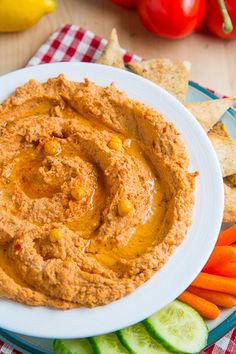 hummus with carrots, celery, and crackers on a plate