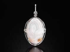 A beautiful Oval White Lace Agate Pendant set in Argentium Sterling Silver. This piece was activated in ceremonies at Mount Shasta and Bali. I created this pendant on the powerful island of Bali. When you purchase this magical creation, please send me your phone number and email address. The Indonesian Post Office requires this information when I mail your package out to you. White Agate Cabochon Jewelry, Elegant Agate Oval Pendant Jewelry, Oval White Wire Wrapped Jewelry, White Agate Round Pendant Jewelry, White Agate Wedding Jewelry, Mount Shasta, Agate Pendant, Lace Agate, Pendant Set