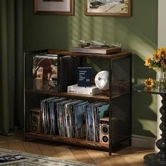 an entertainment center with cd's, cds and other items on it in a living room