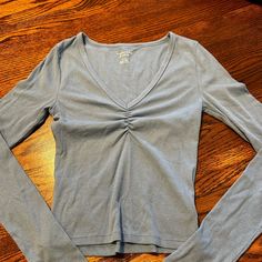 Perfect Condition, Never Worn, Ruched At The Bust, Tight Fitting, Blue Is Lighter Than Picture Casual Light Blue Ruched Top, Casual Long Sleeve Ruched Tops, Blue Ruched Long Sleeve Top, Blue Long Sleeve Ruched Top, Casual Ruched V-neck Top, Casual V-neck Ruched Tops, Casual Blue Ruched Top, American Eagle Outfitters, American Eagle