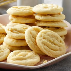 a pink plate filled with cookies on top of a table