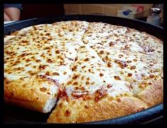 a pizza sitting on top of a pan covered in cheese