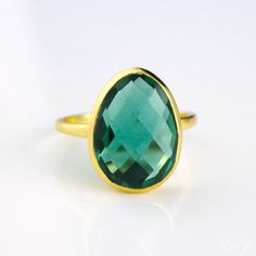 Get the "WOW" factor with this showstopper of a ring. The color of this tourmaline quartz stone is of a vibrant emerald green which is just stunning. Nicely sized with a soft teardrop or egg shape to it - one end is a bit more narrow than the other. Perfect in either 18k gold plated or 925 sterling silver. Gemstone size is 13mm x 16mm. Please note that due to the open back style of this ring, if you are between sizes, we recommend sizing down. Tourmaline Quartz, Green Tourmaline Ring, Bezel Set Ring, Oval Ring, Tourmaline Ring, Silver Rings Handmade, Tourmaline Gemstone, Green Tourmaline, October Birth Stone