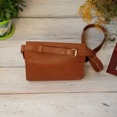 "Leather Crossbody Bag, available in a stunning range of 7 colors. This small leather purse is the perfect women's shoulder bag, offering both style and practicality in a soft and compact design. Every handbag is made with 100% genuine leather. This bag is the perfect helper, you can put a lot of objects in it and your hands and pockets will be free. Size bag: - Length --  8.6\" (22 cm) - Height -- 6.3\" (16 cm) - Deepth -- 2.7\" (7 cm) ----------------------------------------------------- Each accessory can differ in color from the photo, which makes them unique. Since this is a natural leather, small natural irregularities, like scars, stitches, bumps etc. are not reworked. They emphasize the nature of the leather and are a proof of quality, not a quality defect. If you want to see more Refillable Leather Journals, Small Leather Purse, Leather Binder, Brown Leather Backpack, Small Leather Bag, Bags Leather Handbags, Women Crossbody Bag, Crossbody Bag Women, Mini Crossbody Bag