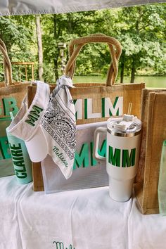 bags and cups are sitting on a table in front of a sign that says mmm