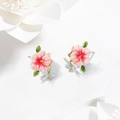 Hibiscus Earrings, fine jewelry design, come from Selenichast jewelry store. They are popular and on sale now. These are special enamel jewelry about hibiscus. They are classic jewelry too. Stunning hibiscus jewelry gives satisfaction to women to add a flowery, sweet and elegant touch to their everyday outfits. Lovely hibiscus jewelry that features enameled white-pink blooms, green leaves and a light blue butterfly give us delight in its loveliness and sweetness while its exquisite enameled work Hibiscus Jewelry, Hibiscus Earrings, Light Blue Butterfly, Fine Jewelry Design, Enamel Flower, Classic Jewelry, Fine Jewelry Designers, Affordable Jewelry, Enamel Jewelry