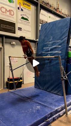 a person on a trampoline doing tricks in a room with other people around