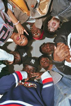 a group of young people standing in a circle with their hands on top of each other