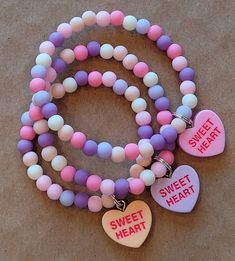 "Sweet \"Sweetheart\" bracelet in pastel colors." Sweet Multicolor Heart-shaped Jewelry, Cute Multicolor Heart Bracelet For Valentine's Day, Cute Pink Heart Bracelet With Heart Charm, Trendy Personalized Pink Heart Bracelet, Cute Pink Beaded Bracelet With Heart Charm, Trendy Pink Heart Charm Bracelet, Cute Multicolor Heart-shaped Bracelets, Friendship Sweet Pink Bracelets, Playful Pink Heart-shaped Bracelets