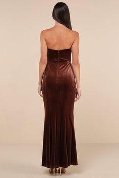 a woman wearing a brown velvet dress with high slits on the side and back